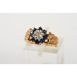 A 9CT GOLD SAPPHIRE AND DIAMOND CLUSTER RING, the central single cut diamond within an illusion