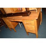 A LIGHT OAK DESK with six various drawers, width 137cm x depth 76cm x height 76cm