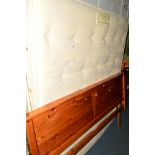 A SEALY 6' DIVAN BED with mattress and pine headboard