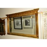 A REPRODUCTION GILT FRAMED BEVELLED EDGE OVERMANTEL MIRROR, approximately 105cm x 66cm, together