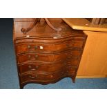 A REPRODUCTION MAHOGANY AND BANDED SERPENTINE CHEST OF FOUR LONG GRADUATED DRAWERS, with a