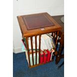 A REPRODUCTION BURR WALNUT TWO TIER REVOLVING BOOKCASE, with a burgundy tooled leather inlay top,