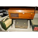 A MID CENTURY CAROUSEL RECORD PLAYER, in a walnut veneered cabinet standing on tapering turned black