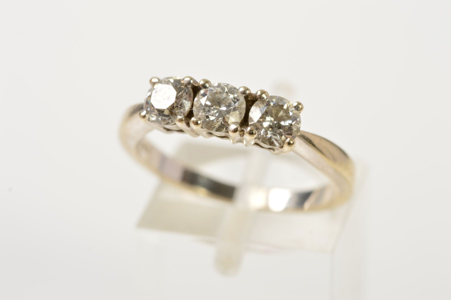 AN 18CT GOLD THREE STONE DIAMOND RING, designed as three brilliant cut diamonds, each within a