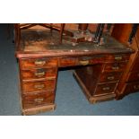 AN EDWARDIAN STAINED MAHOGANY PEDESTAL DESK, with painted insert top and nine various drawers, width