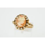 A 9CT GOLD CAMEO RING, the central oval cameo panel depicting a lady in profile, within a