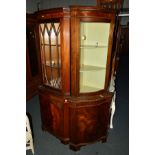 A REPRODUCTION MAHOGANY SERPENTINE GLAZED CORNER CUPBOARD, together with another corner cupboard (2)