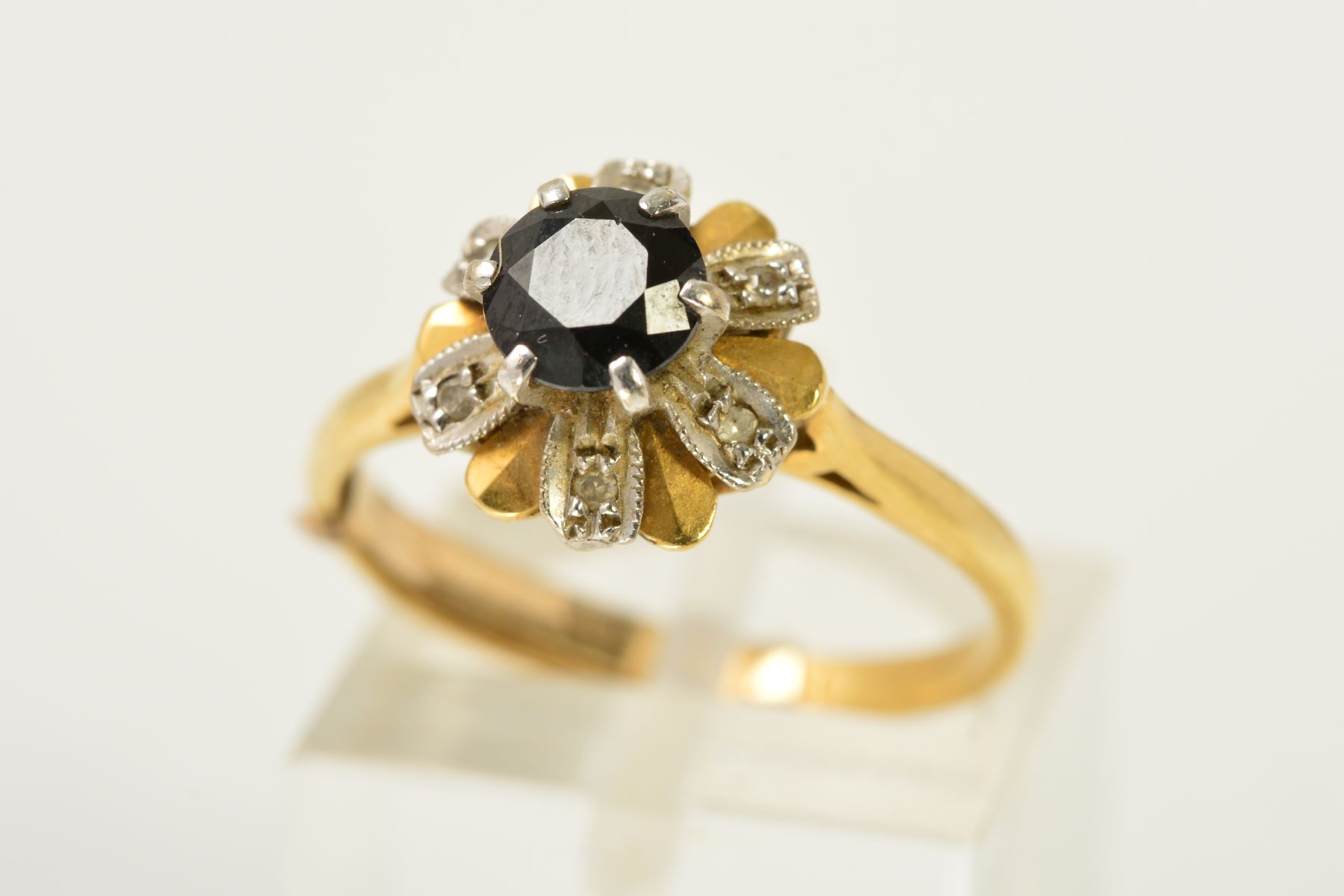 AN 18CT GOLD, SAPPHIRE AND DIAMOND CLUSTER RING, the circular sapphire within a raised claw