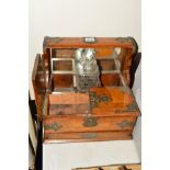 A VICTORIAN OAK AND BRASS MOUNTED TANTALUS, to house three decanters (only one present), with secret