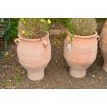 A PAIR OF LARGE TERRACOTTA AMPHORA SHAPED GARDEN URNS with triple hooped handles, height 70 cm x