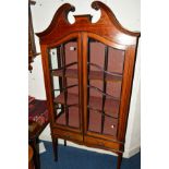 AN EDWARDIAN MAHOGANY AND BANDED ASTRAGAL GLAZED TWO DOOR DISPLAY CABINET, with swan neck