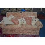 A GAINSBOROUGH LIMITED FLORALLY GOLD UPHOLSTERED THREE SEATER BED SETTEE