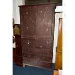 A VICTORIAN STAINED MAHOGANY TWO DOOR LINENPRESS, revealing four pine slides with raised back and