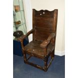 AN 19TH CENTURY AND LATER OAK WAINSCOTE CHAIR, shaped cresting, carved armrest, above block and