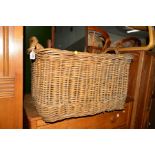 A WICKER TWIN HANDLED BASKET