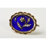 A MID VICTORIAN GOLD MEMORIAL BROOCH, blue enamel inlaid with floral seed pearl detail, oval shape