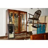 A WALNUT TWO DOOR CHINA CABINET together with an oak wheelback rocking chair, small mirror, sewing