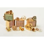 A SELECTION OF MAINLY GOLD JEWELLERY, to include four rectangular charms enclosing notes, a heart