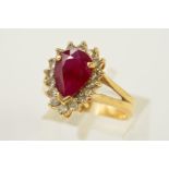 AN 18CT GOLD GLASS FILLED RUBY AND DIAMOND CLUSTER RING, designed as a pear shape glass filled