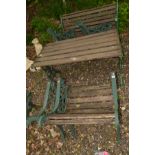 A PAINTED CAST IRON GARDEN BENCH AND TABLE SET with foliate decoration and wooden slats,