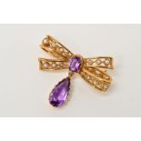 A 9CT GOLD AMETHYST AND SEED PEARL FANCY BOW BROOCH, measuring approximately 24.8mm x 19mm, pin