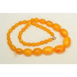 A PLASTIC BEAD NECKLACE, designed as graduated barrel shape beads measuring 10mm to 27mm to the