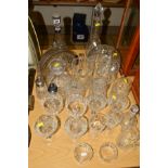 A QUANTITY OF CUT GLASS, to include decanters, storage vessels, tankards, drinking glasses and