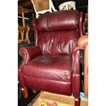 AN OXBLOOD LEATHER WING BACK ARMCHAIR