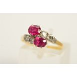 A RUBY AND DIAMOND CROSS OVER RING, designed as a central, oval rubies in claw settings, with two