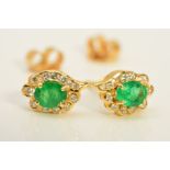 A MODERN PAIR OF EMERALD AND DIAMOND OVAL CLUSTER EARRINGS, emeralds measuring approximately 5mm x