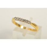 A GOLD SEVEN STONE DIAMOND RING, designed as a row of seven brilliant cut diamonds within claw