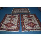 THREE SIMILAR AFSHAR STYLE RUGS, red and cream ground of a geometric design, Iran label to underside
