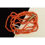 A CORAL BRACELET, designed as six rows of irregular shaped coral beads, to the base metal tube and