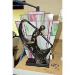 A MODERN ART DECO STYLE LAMP FEATURING A FEMALE FIGURE DANCING IN FRONT OF A STAINED GLASS STYLE