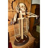 A DECORATIVE CD RACK IN THE FORM OF A SKELETON