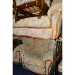 A FLORAL UPHOLSTERED THREE PIECE SUITE comprising a three seater settee and two armchairs (3)