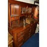 AN EARLY 20TH CENTURY OAK DRESSER, the top with double lead glazed doors above a bevelled edge