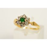 AN 18CT GOLD EMERALD AND DIAMOND CLUSTER RING, the central circular emerald within a brilliant cut