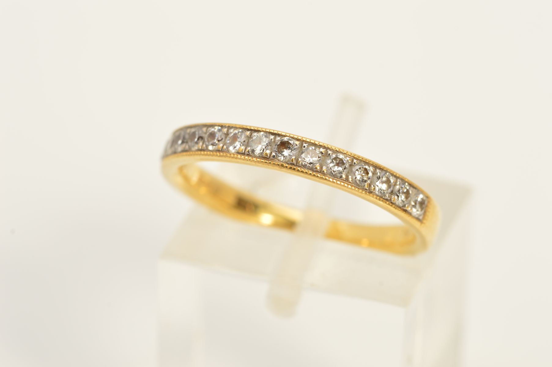 AN 18CT GOLD DIAMOND HALF ETERNITY RING, set with fifteen brilliant cut diamonds, estimated total