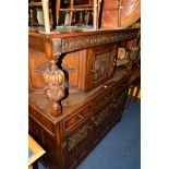 A REPRODUCTION CARVED OAK COURT CUPBOARD with a single cupboard above three drawers, width 137cm x