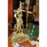 A 20TH CENTURY BRASS UMBRELLA STAND featuring a standing gentleman, together with a smoked glass and