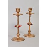 IN THE MANNER OF A.W.N.PUGIN, a pair of aesthetic movement brass candlesticks, reeded capitals,