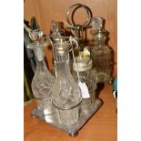 A LATE VICTORIAN/EDWARDIAN FOUR BOTTLE CRUET, together with another with six bottles, both with