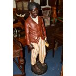 A GOLDSCHEIDER STYLE PLASTER FIGURE OF A YOUNG BOY STANDING, dressed as a street urchin on a