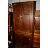 A GEORGIAN OAK PANELLED FOUR DOOR FLOOR STANDING CORNER CUPBOARD, width 112cm x depth 68cm x