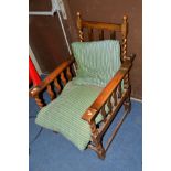 A 20TH CENTURY OAK BARLEY TWIST FIRESIDE CHAIR with an adjustable back