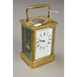 A FRENCH BRASS CARRIAGE CLOCK, the white face with black Roman numerals, glass sides and back,