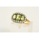 A PERIDOT AND OPAL DRESS RING, designed as three graduated oval peridots within a claw set, circular