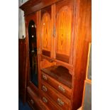 AN EDWARDIAN PITCH PINE COMPACTUM WARDROBE, with single bevelled mirrored door and four various