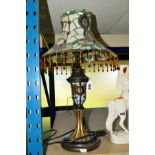 A REPRODUCTION LEADED GLASS TABLE LAMP, fringed shade